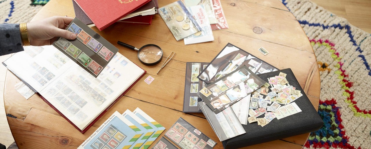 Man collector checking out his philatelic collection Portrait